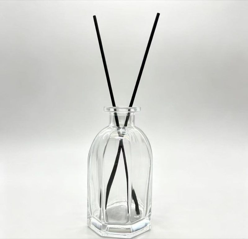 Clear glass reed diffuser bottle with black reeds