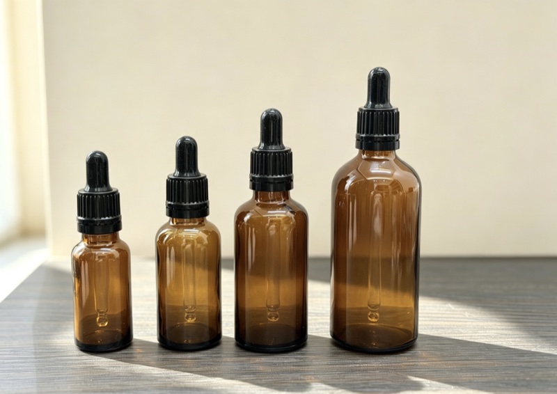 Amber glass dropper bottles in four sizes with black droppers