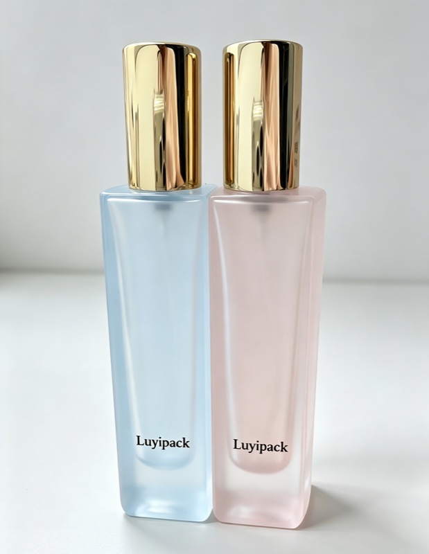 Frosted blue and pink square glass bottles with gold caps