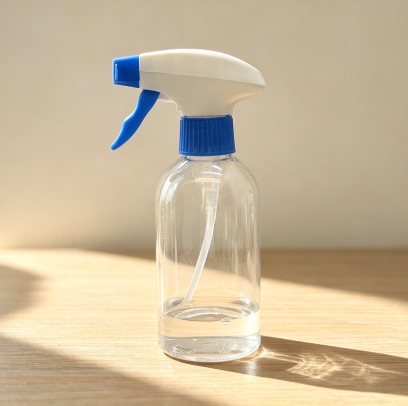Boston round clear bottle with white and blue trigger sprayer