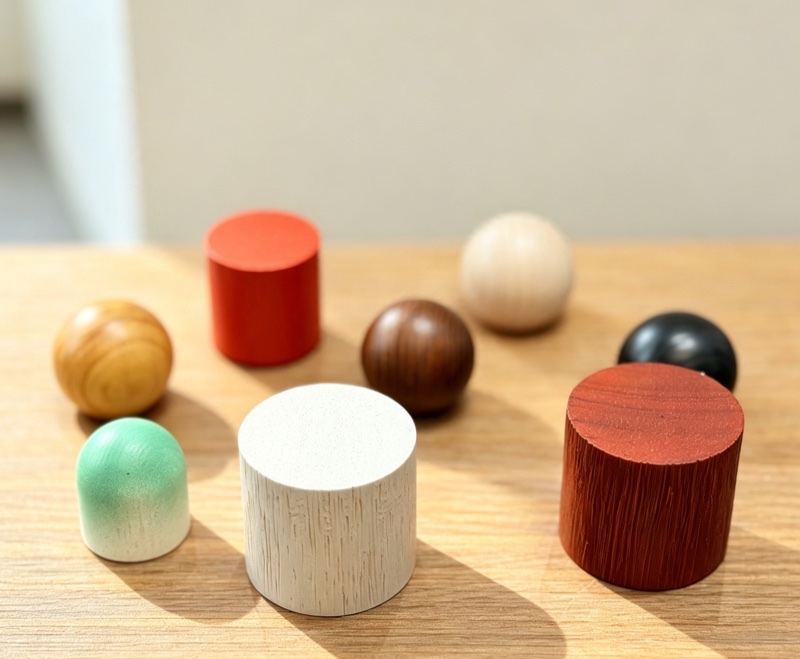 Wooden ball and cylinder caps in natural, stained and painted finishes