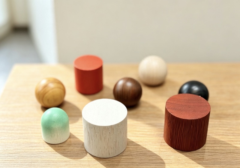 Wooden caps in orange, white, red, green and black finishes on a table